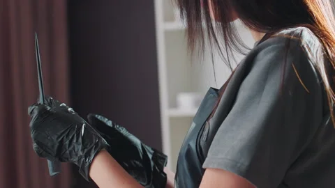 Professional stylist readying dye for application, skilled stylist wearing Stock Footage 330603672