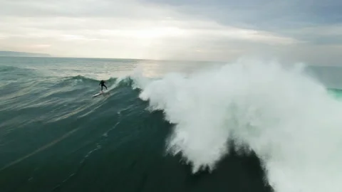 Professional surfer riding big waves on surfboard in ocean during day time Stock Footage 156633540