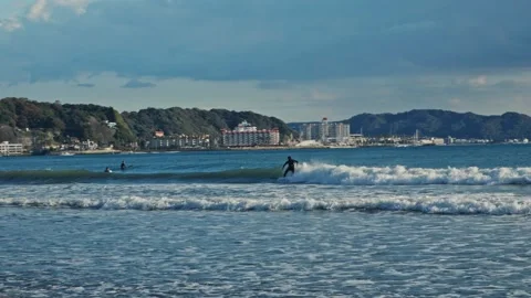 Professional surfer riding ocean wave in zushi Stock Footage 324875903