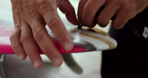 Professional surfer tying safety string to surfboard before surfing in ocean Stock Footage 156016988