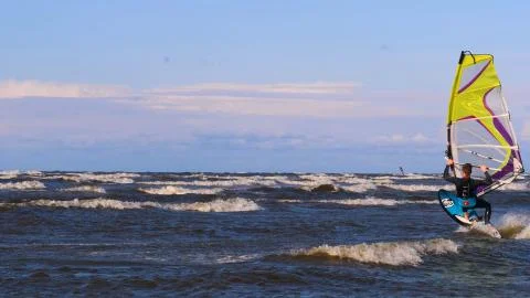 Professional surfer in the wind preparing the wind in the sea to the ocean. Stock Photos