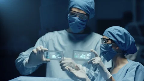 Professional Surgeon and Assistant Analyze Patient Diagnosis Data Stock Footage 120219846