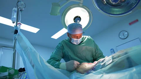 Professional surgeon doing plastic operation. Doctor in medical mask  Stock Footage 158367890