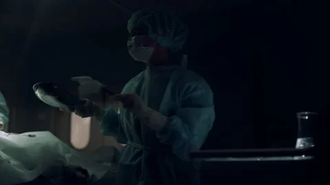 Professional surgeon operating in dark emergency room. Medical team cooperation Stock Footage 179412372