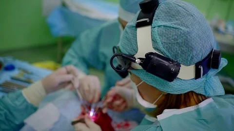 Professional surgeon performing difficult opeartion on a nose in a clinic. Stock Footage 96454585