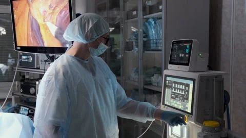 Professional surgeon using advanced medical equipment during surgery Stock Footage 306167783
