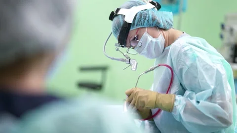 Professional surgeons performing invasive surgery on a patient in a hospital Vídeo Stock 179830842
