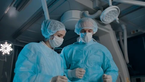 Professional surgeons preparing for surgery Stock Footage 127198838