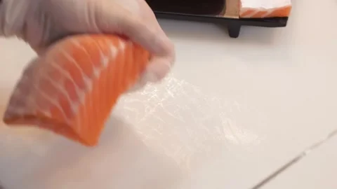 Professional Sushi Chef Slicing Fresh Salmon Fillet for Sashimi Stock Footage 333489447