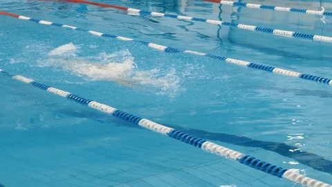 Professional swimmer in cap breathing performing the butterfly stroke Video stock 71926043