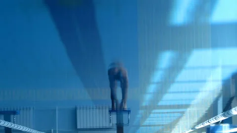 A professional swimmer dives into the pool, picking up a lot of splashes Stock Footage 119500673