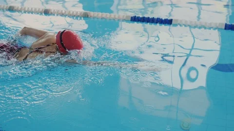 Professional swimmer trains in the pool. She swims like a crawl and skillfully Stock Footage 112063565