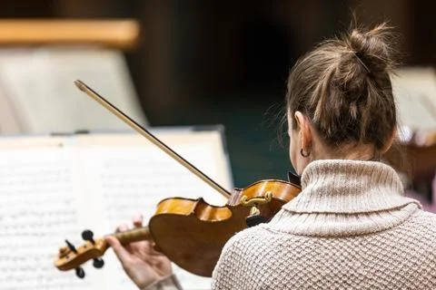 Professional symphonic string orchestra performing on stage and playing a Stock Photos