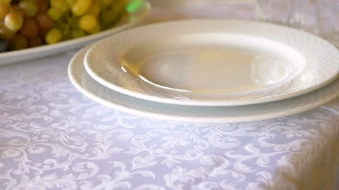 Professional table setting close-up. Plates and forks are placed on a white Stock Footage 98761993