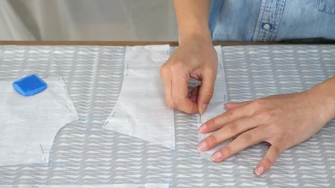 Professional tailor creates a template of the future dress. Slow motion Stock Footage 90376362