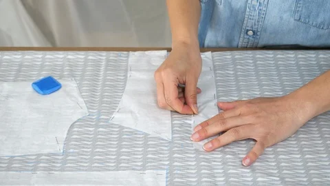 Professional tailor creates a template of the future dress Stock Footage 90386282