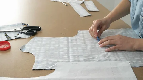 Professional tailor creates a template of the future dress.Dolly shot Stock Footage 90423679