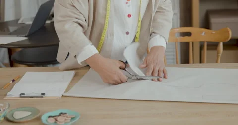 Professional Tailor Cutting Fabric Pattern For Bespoke Clothing In Workshop.. Stock Footage 340134663