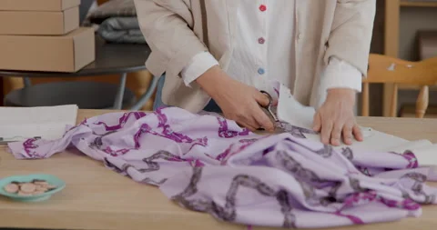Professional Tailor Cutting Patterned Fabric With Scissors In A Sewing Atel.. Stock Footage 340134787