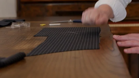 Professional tailor transferring transferring pattern markings and drawing on Stock Footage 127230053