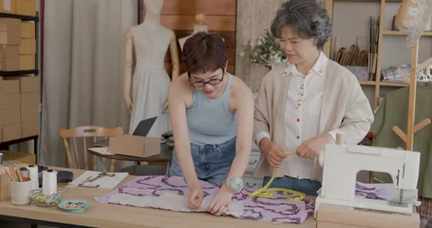Professional Tailors Measuring And Pinning Fabric Patterns In A Creative Fa.. Stock Footage 340134962