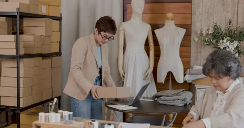 Professional Tailors Packing Clothing Orders In Modern Fashion Studio Mediu.. Stock Footage 336248094