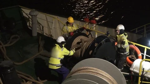 Professional tanker deck crew arranges large mooring lines Stock Footage 128859180
