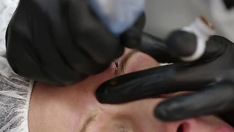 Professional tattooist making permanent make up Stock Footage 73767785