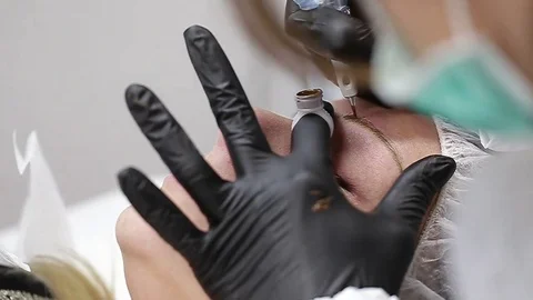 Professional tattooist making permanent make up Stock Footage 73767792