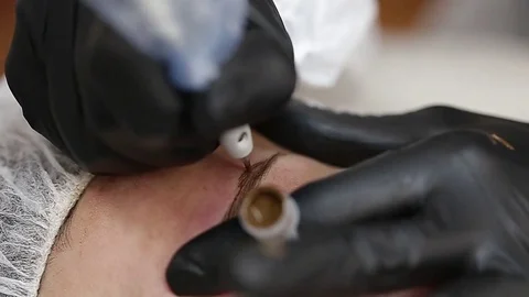 Professional tattooist making permanent make up Stock Footage 73767830