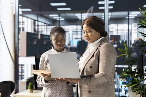 Professional team analyzing archived data on a modern device Stock Photos