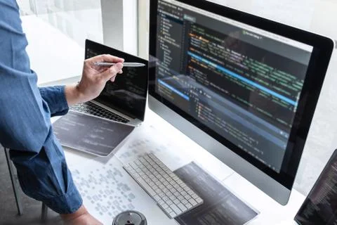 Professional Team of programmer working on project in software development co Stock Photos