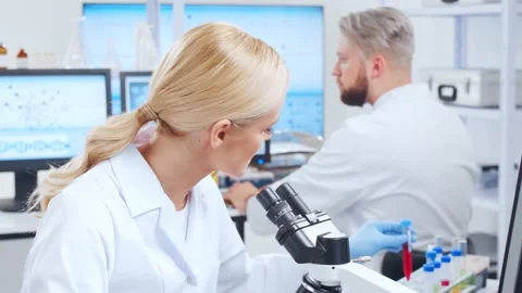 Professional team of scientists is working on a vaccine in a modern scientific Stock Footage 148570752