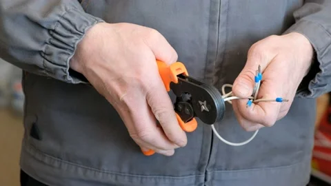Professional technician crimps a multi-core cable using crimping tool. Stock Footage 235812125