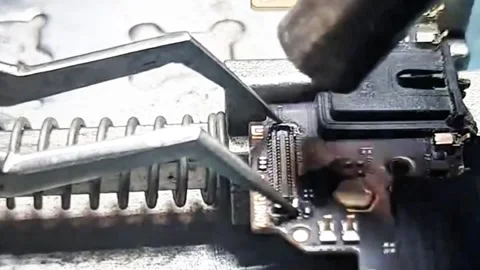 Professional Technician Removing FPC Connector from Smartphone Motherboard Stock Footage 333610573