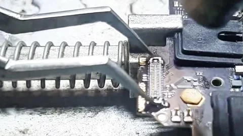 Professional Technician Removing FPC Connector from Smartphone Motherboard Stock Footage 333610576