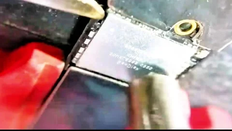 Professional technician removing micro chip from smartphone motherboard Stock Footage 332834040