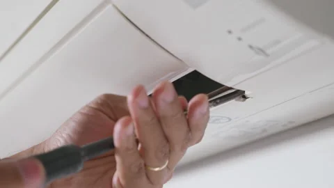 Professional technician screw with screwdriver placing back after clean filter Video stock 200858792