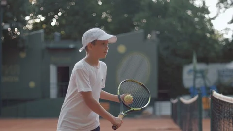 Professional tennis player boy hitting racket on ball at court close up outdoors Stock Footage 111005573
