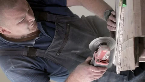 Professional tiler cutting tile with angle grinder. Stock Footage 247339907