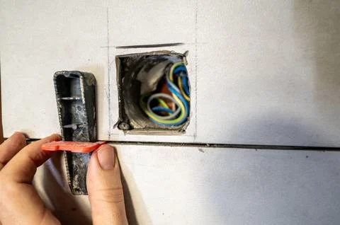 Professional tiler installing ceramic wall tiles with a leveling system to .. Stock Photos