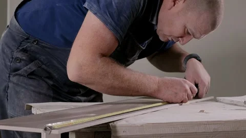 Professional tiler measuring and sticking with tape for cutting ceramic tiles  Stock Footage 247340298