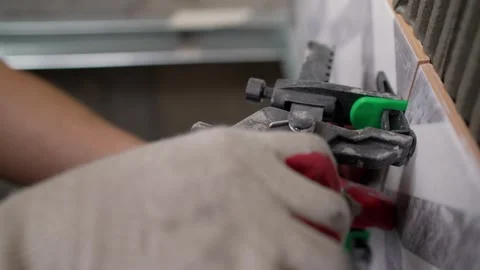 Professional tiler using leveling system for ceramic tiles Stock Footage 323664666