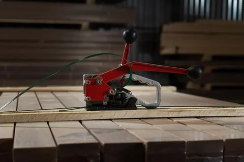Professional tool for installing ties on pallets in the workshop, demonstrating Stock Photos