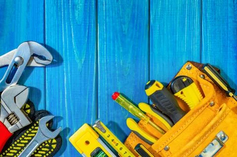 Professional tool kit for a builder in a bag on blue wooden background also p Stock Photos