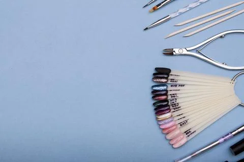 Professional tools for creating manicure. Flat lay on a blue background. Co.. Stock Photos