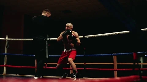 The professional trainer conducts training for the boxer Stock Footage 83877412