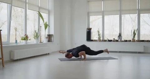 Professional trainer practices flow yoga in private class Stock Footage 156765642