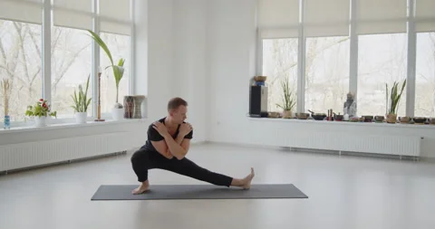 Professional trainer practices flow yoga in private class Stock Footage 156766194