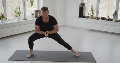 Professional trainer practices flow yoga in private class Stock Footage 156766552